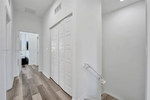 a view of a workspace with furniture and wooden floor