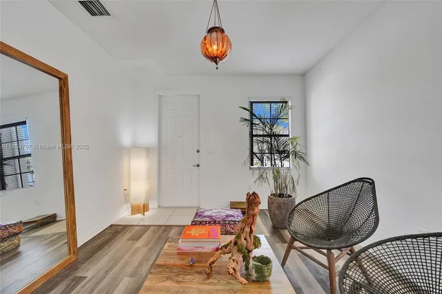 a living room with furniture and a potted plant