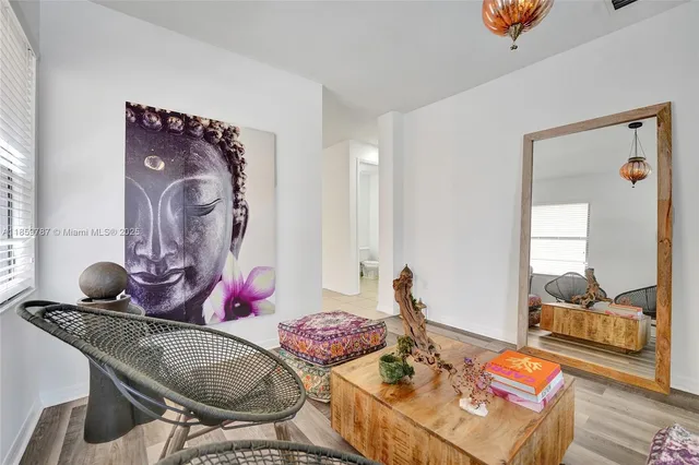 a living room with furniture and a potted plant