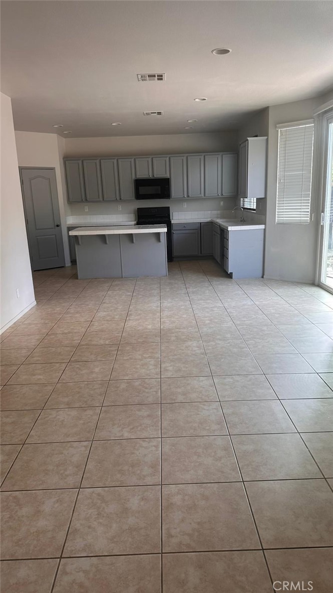 3888 Strand Way Perris, CA 92571 - Photo 5 of 7 a view of a kitchen with furniture and cabinets