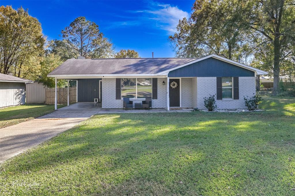 105 Cleveland Street Benton, LA 71006 - Photo 1 of 1 a front view of a house with a garden and yard