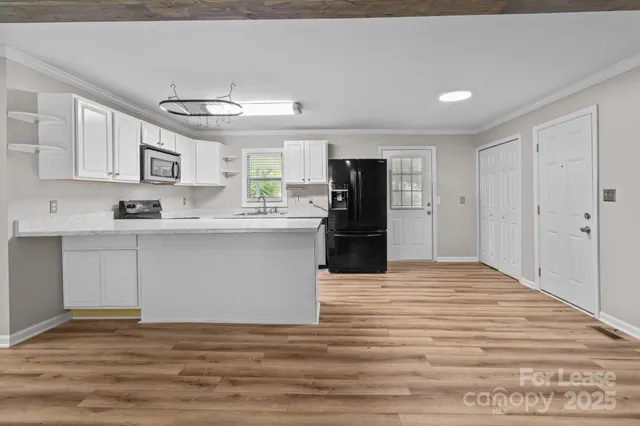 a kitchen with stainless steel appliances granite countertop a refrigerator sink and cabinets