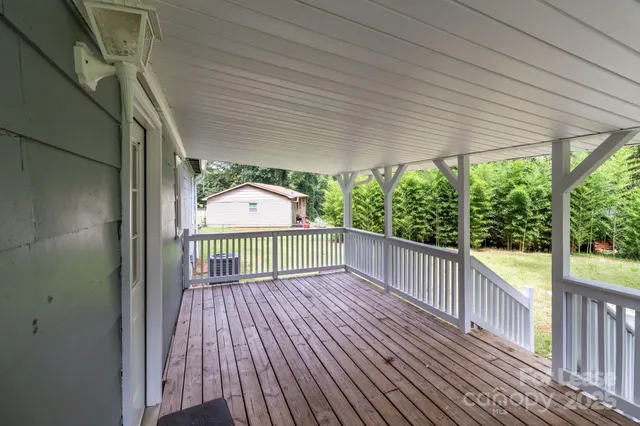 a view of a balcony with wooden floor