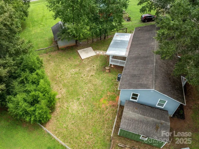 aerial view of a house with pool garden