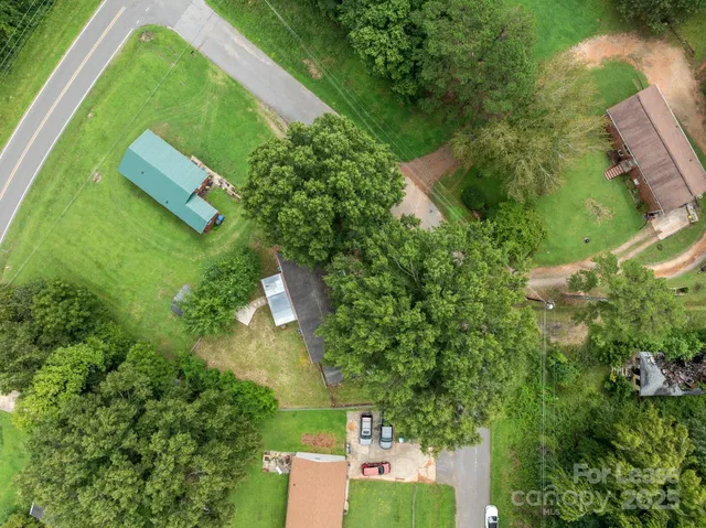 an aerial view of a house with a yard basket ball court and outdoor seating