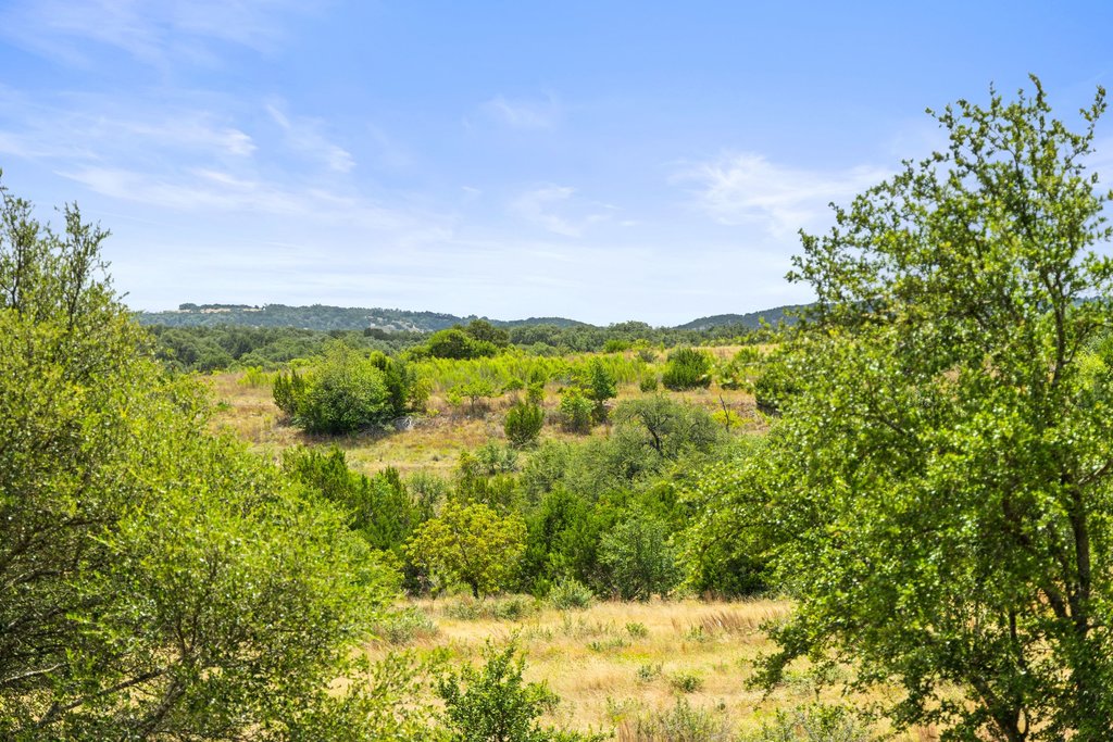 207 Verbena Road Johnson City, TX 78636 - Photo 1 of 40 Rolling hills and natural green landscapes create a serene backdrop for future development.