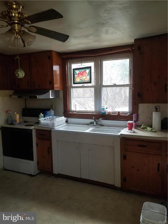 107 Rock Ridge Road Ottsville, PA 18942 - Photo 8 of 10 a kitchen with stainless steel appliances granite countertop a stove a sink and a microwave