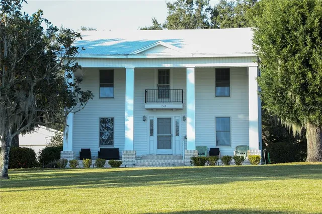 a view of building with yard in front of it