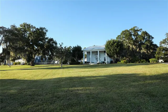 a front view of a house with a big yard