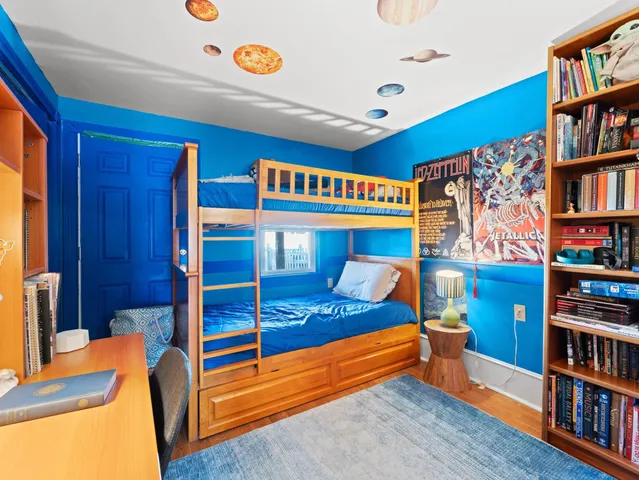 a bedroom with furniture and a book shelf