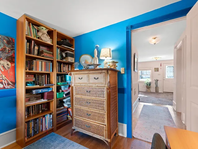 a view of bedroom with furniture and book shelf