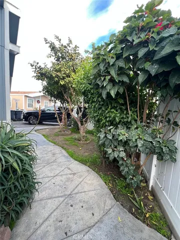 a view of empty room with wooden floor and furniture