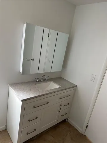 a bathroom with a sink and vanity