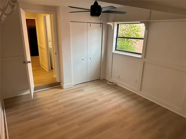 an empty room with windows and closet
