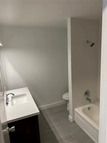 a bathroom with a sink a toilet and bathtub