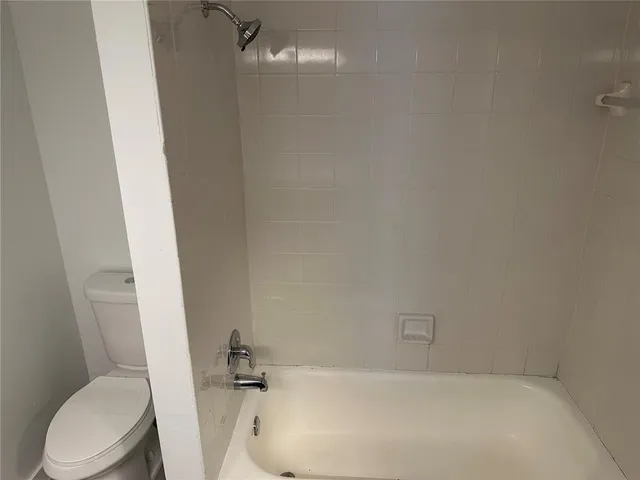 a bathroom with a bathtub and toilet