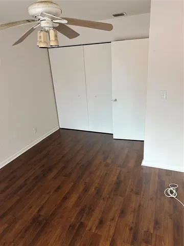 a view of a room with wooden floor