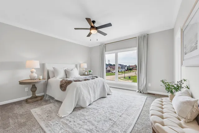 a bed room with bed and a large window