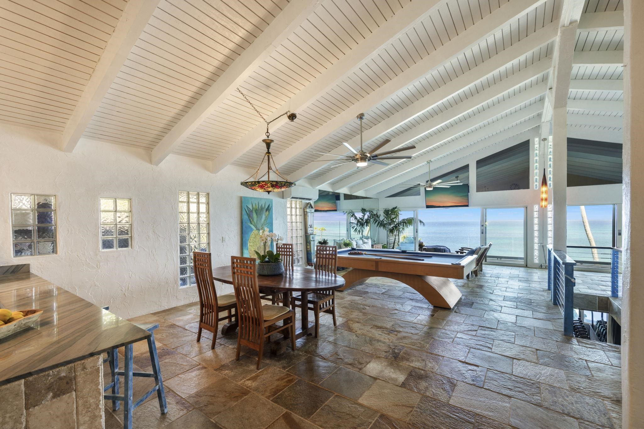 5171 Lower Honoapiilani Road Lahaina, HI 96761 - Photo 12 of 48 a dining room with furniture window and wooden floor