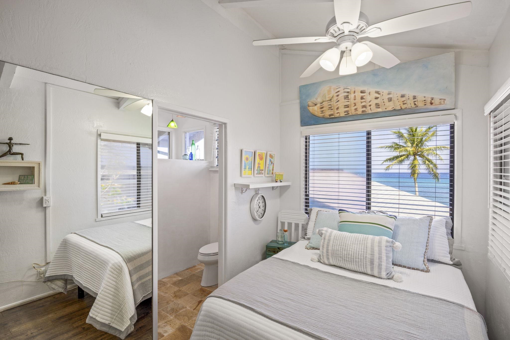 5171 Lower Honoapiilani Road Lahaina, HI 96761 - Photo 21 of 48 a bedroom with a bed dresser and a window