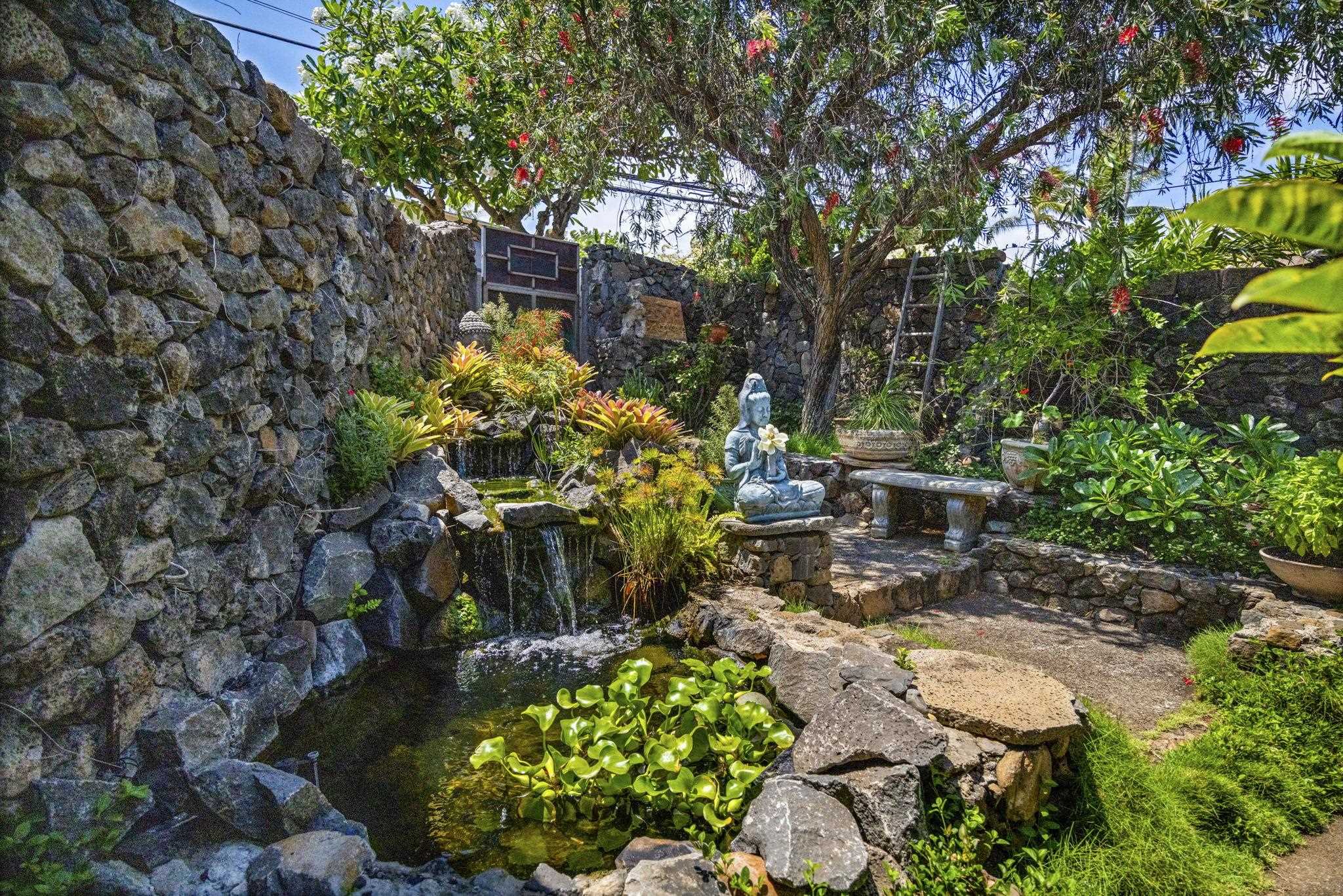 5171 Lower Honoapiilani Road Lahaina, HI 96761 - Photo 35 of 48 a backyard of a house with lots of green space and trees all around