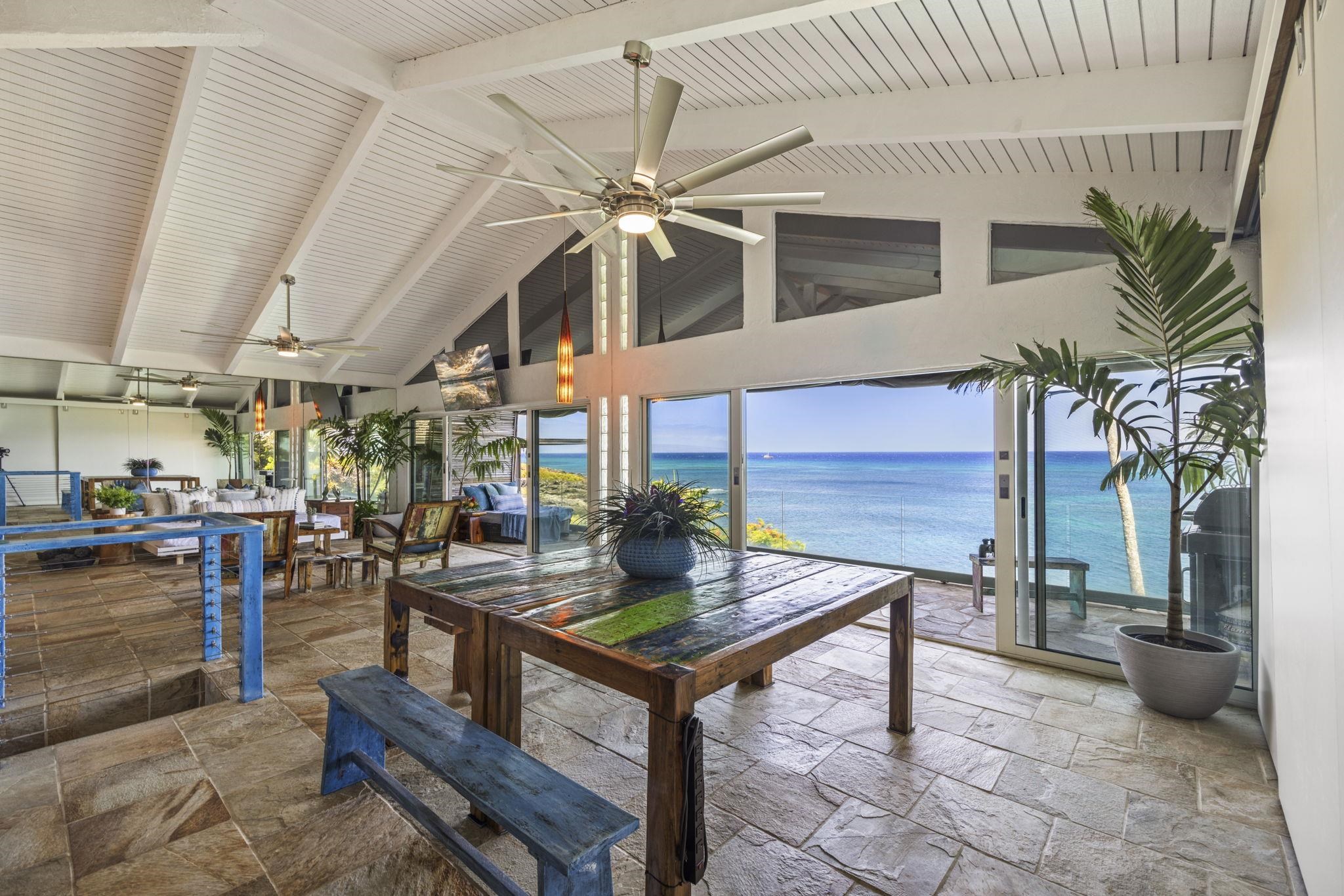 5171 Lower Honoapiilani Road Lahaina, HI 96761 - Photo 4 of 48 a living room with furniture a fireplace and a chandelier