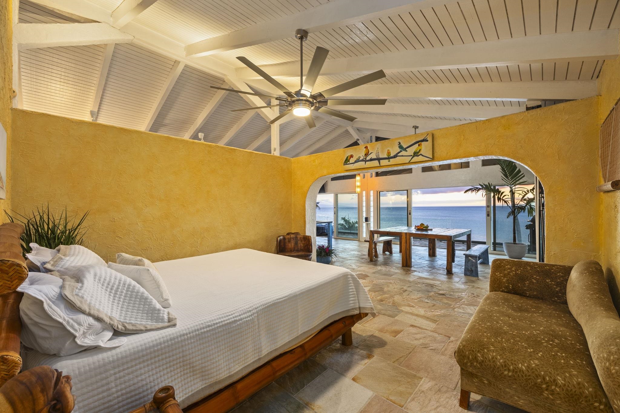 5171 Lower Honoapiilani Road Lahaina, HI 96761 - Photo 43 of 48 a bed room with a bed and a chandelier