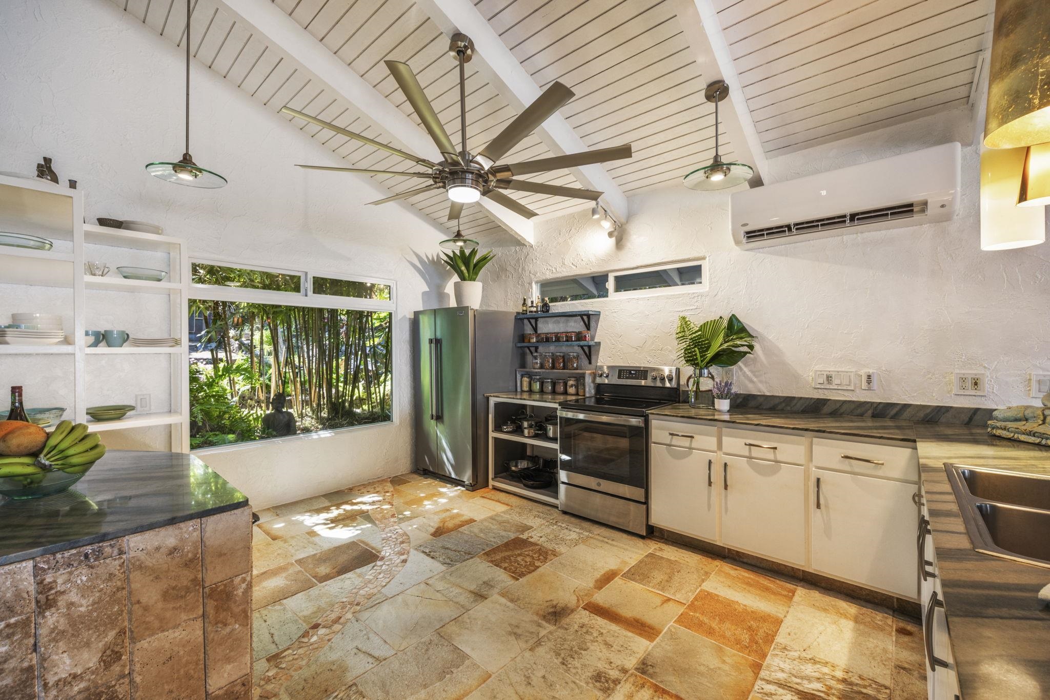 5171 Lower Honoapiilani Road Lahaina, HI 96761 - Photo 7 of 48 a large kitchen with kitchen island granite countertop a large counter space wooden floor and stainless steel appliances