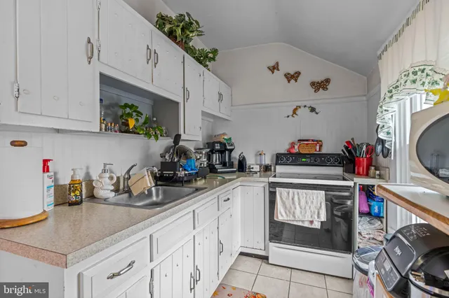 a kitchen with stainless steel appliances granite countertop a sink a stove and cabinets