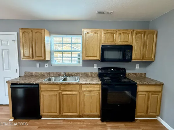 a kitchen with a stove and a microwave