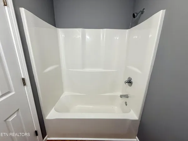 a bathroom with bathtub and shower