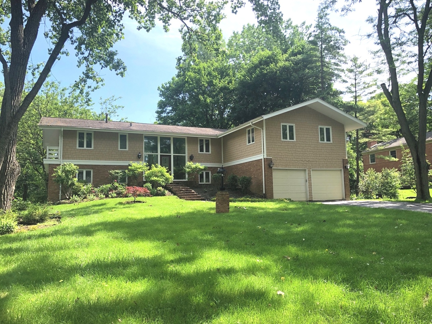 a front view of house with yard and green space