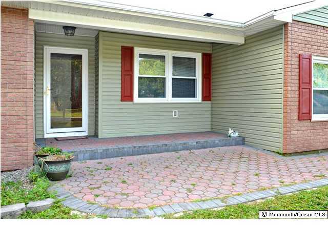 32 Lloyd Road Morganville, NJ 07751 - Photo 2 of 3 a front view of a house with garden