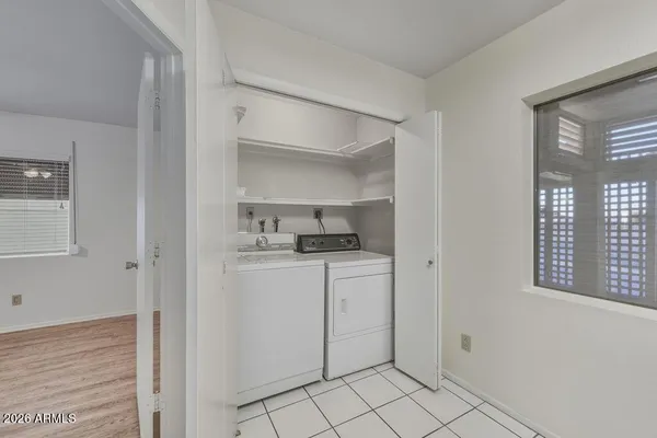 a kitchen with white cabinets and sink