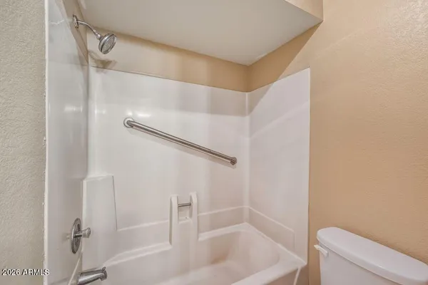 a bathroom with a bathtub and toilet