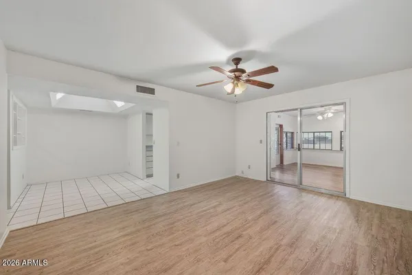 wooden floor in an empty room with a window