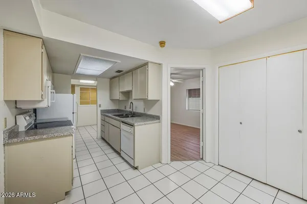 a kitchen with granite countertop a sink and a stove top oven