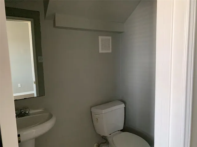 a white toilet sitting next to a bathroom sink