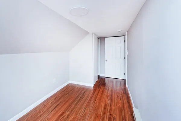 a view of a room with wooden floor and closet