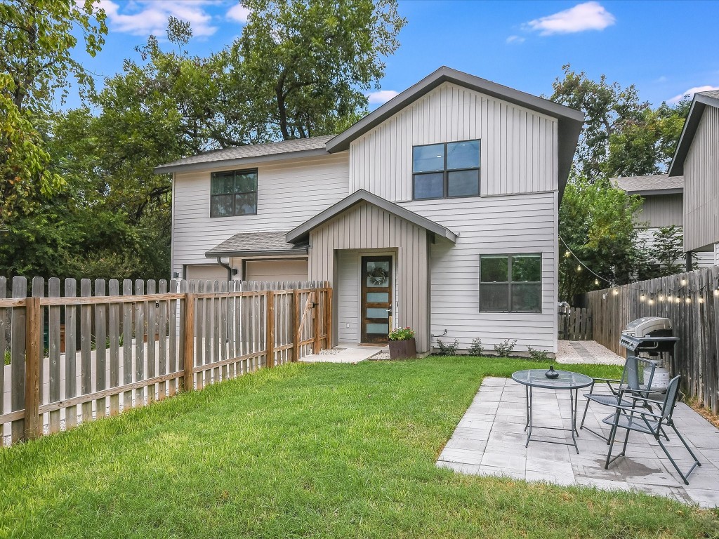 a view of a house with a yard and a garden