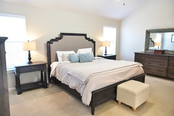 a bedroom with bed and window
