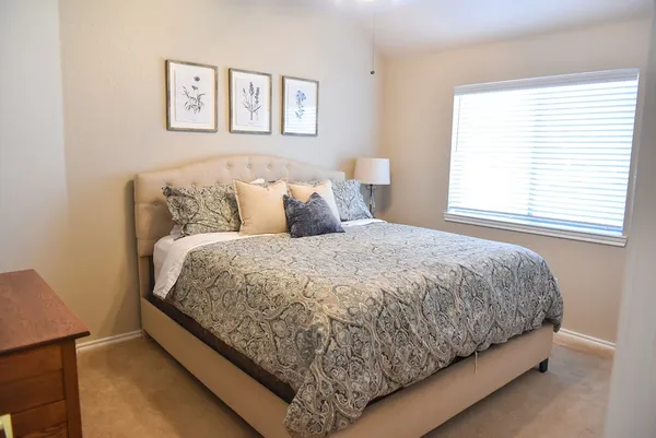 a bed sitting in a bedroom next to a window