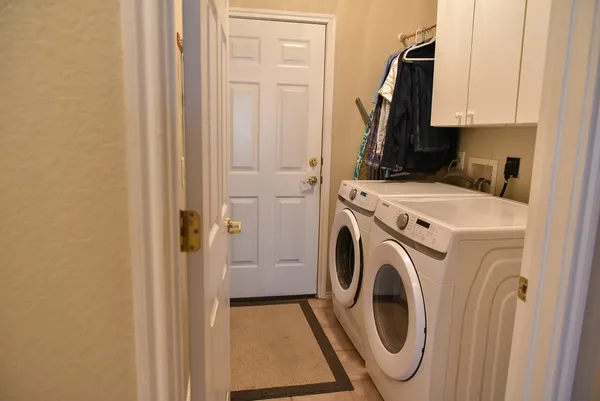 a view of a storage and utility room with washer and dryer