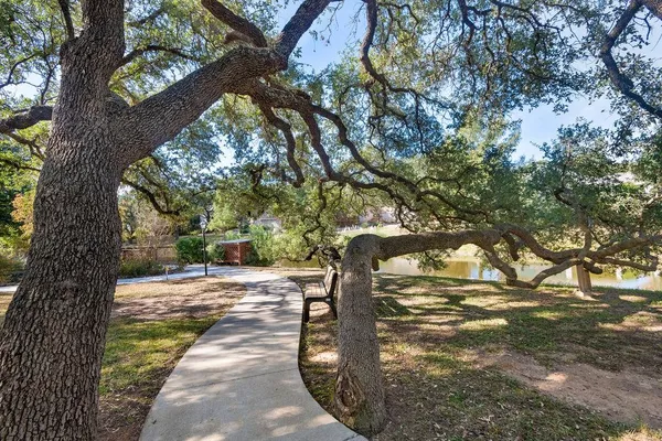 a view of a street with trees on both side of it