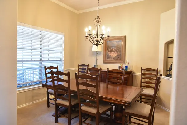 a view of a dining room with furniture and a window