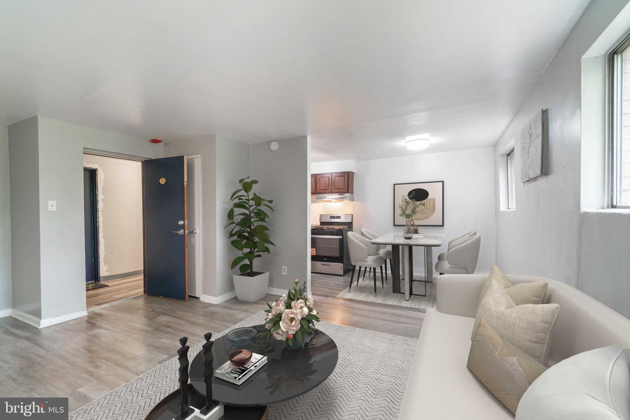 4616 Leiper Street, Unit A8 Philadelphia, PA 19124 - Photo 1 of 12 a living room with furniture and a table