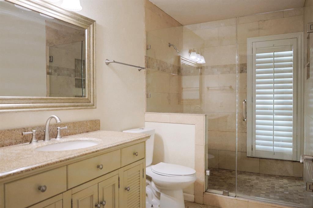 740 Peavy Road Dallas, TX 75218 - Photo 13 of 19 a bathroom with a sink toilet and shower