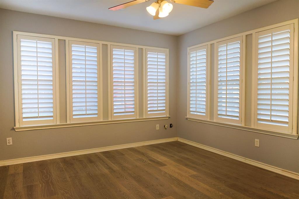 740 Peavy Road Dallas, TX 75218 - Photo 14 of 19 a view of an empty room with a window and wooden floor