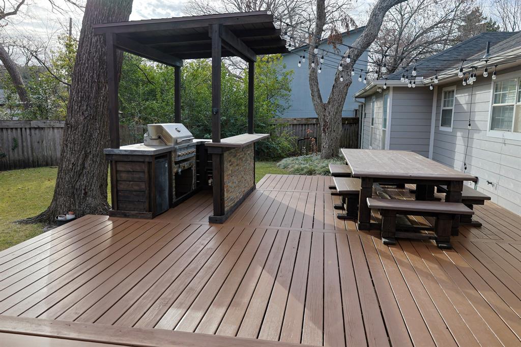 740 Peavy Road Dallas, TX 75218 - Photo 16 of 19 a backyard of a house with wooden floor outdoor seating and yard in the back