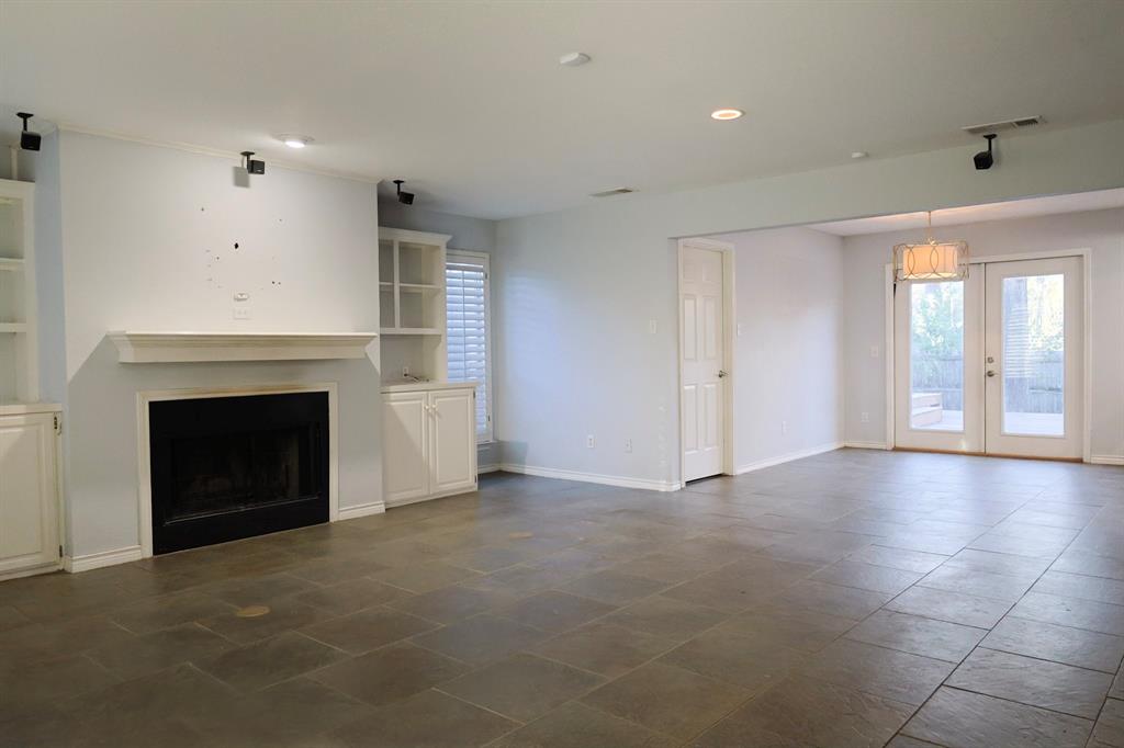 740 Peavy Road Dallas, TX 75218 - Photo 3 of 19 a view of a livingroom with a fireplace and window